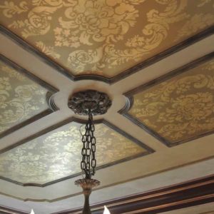 Gilded ornament in patterned ceiling panels